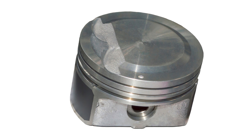 The piston of an automobile internal combustion engine is tilted at an angle