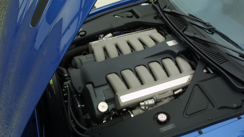 An Aston Martin DB7 GT's engine with the hood propped open