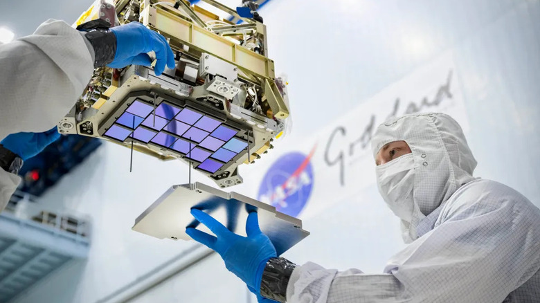 Principal technician Billy Keim installs a cover plate over the detectors for NASA's Nancy Grace Roman Space Telescope in the largest clean room at the agency's Goddard Space Flight Center in Greenbelt, Md., on Feb. 8, 2021.