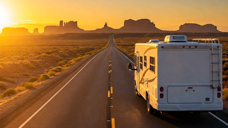 RV driving down a desert road to go camping