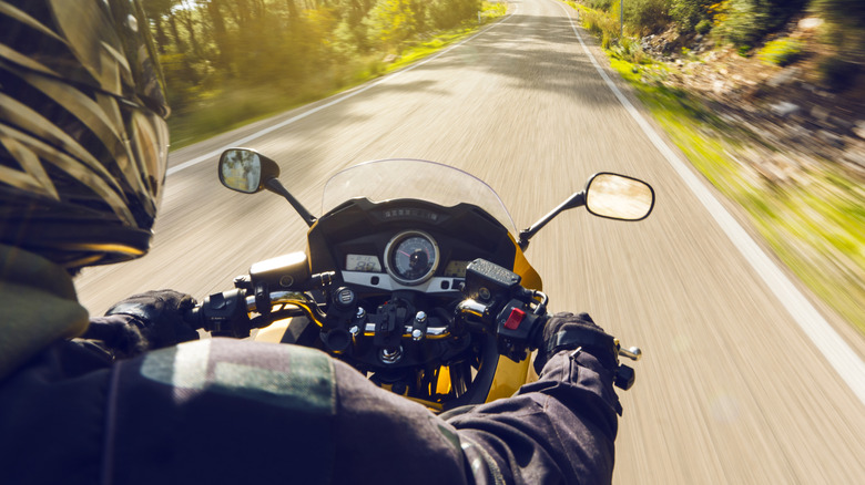 Riding a motorcycle on a paved road