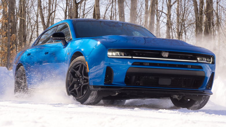 A blue 2026 Dodge Charger R/T kicking up snow