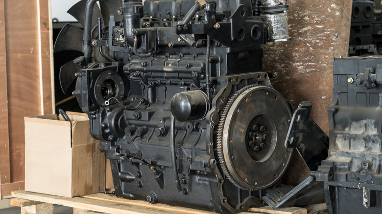 A diesel engine on display next to a cardboard box