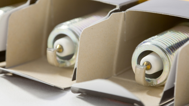 A set of spark plugs in their respective boxes