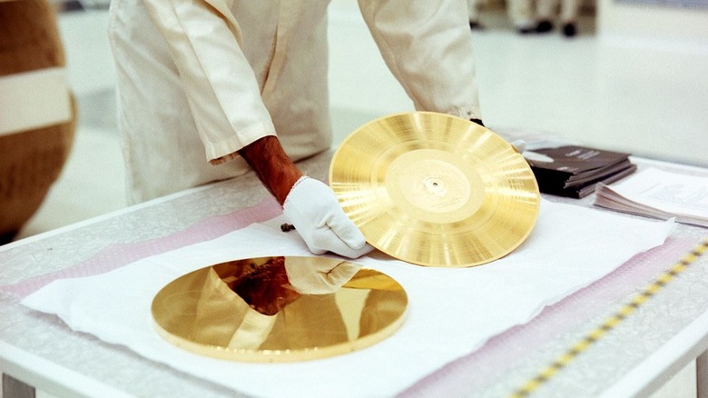 A scientist holds the Golden Record