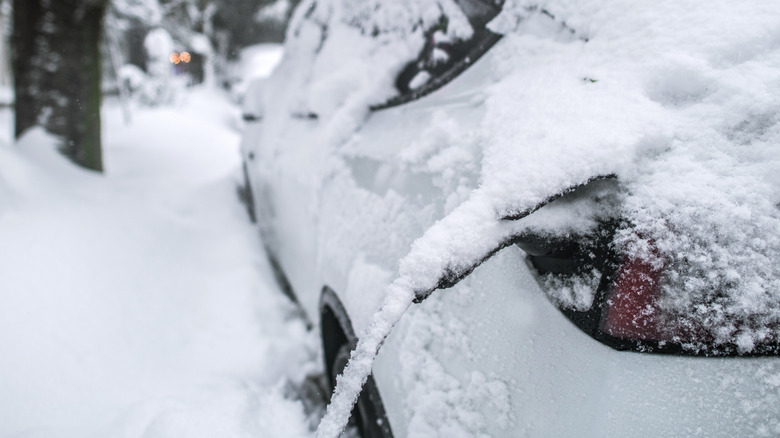 A Tesla charging in the snow.