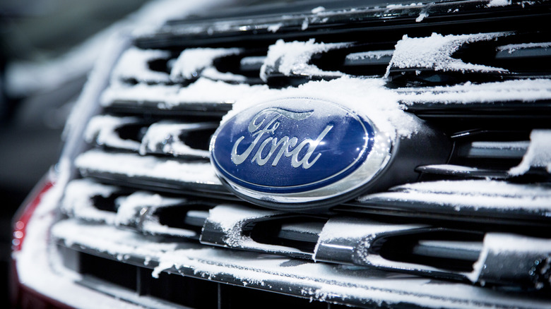 A Ford logo on a vehicle covered in snow