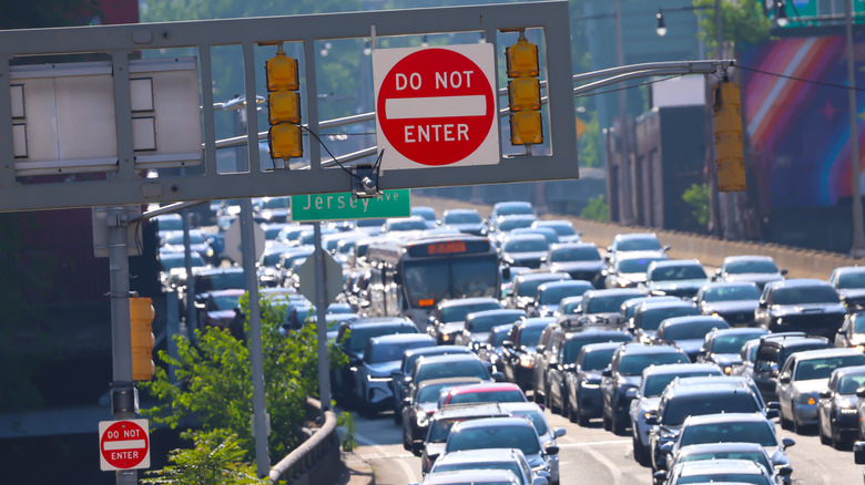 Cars are in a traffic jam in a city.