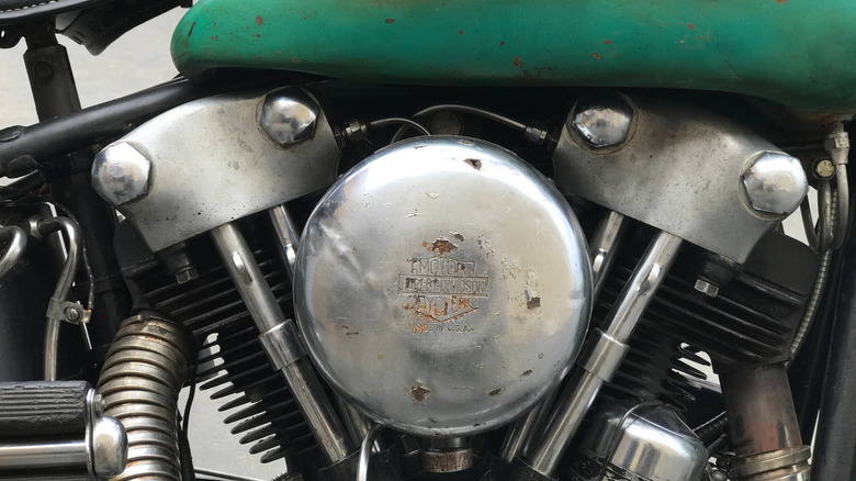 A Harley Knucklehead engine with a rusted logo