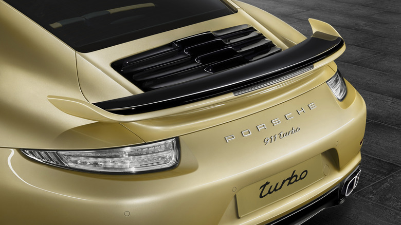 The rear section of a yellow 2015 Porsche 911 Turbo