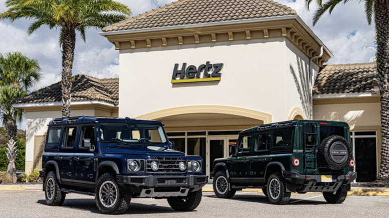 Two Ineos Grenadier SUVs in front of a Hertz