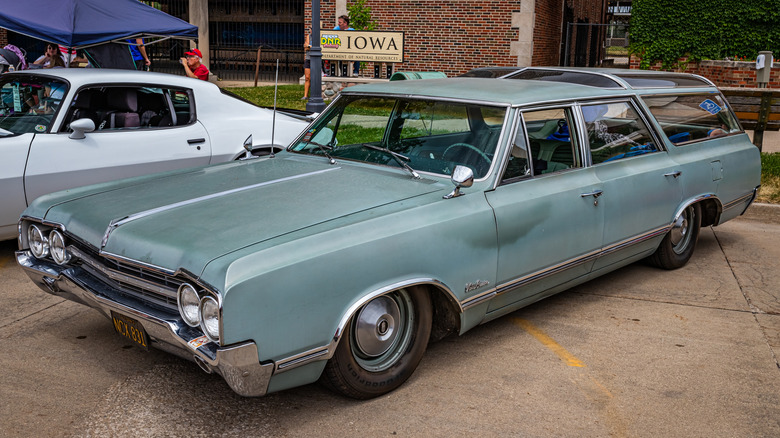 Front/side view of a blue '65 Oldsmobile Vista Cruiser in a parking lot
