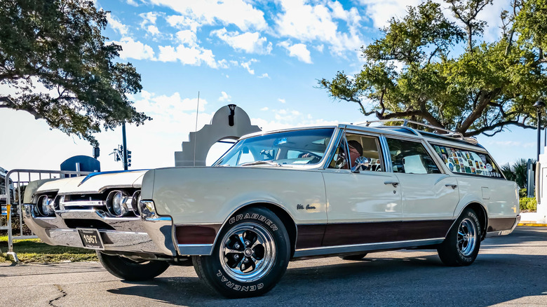 Front-quarter view of a white 1967 Oldsmobile Vista Cruiser on a street