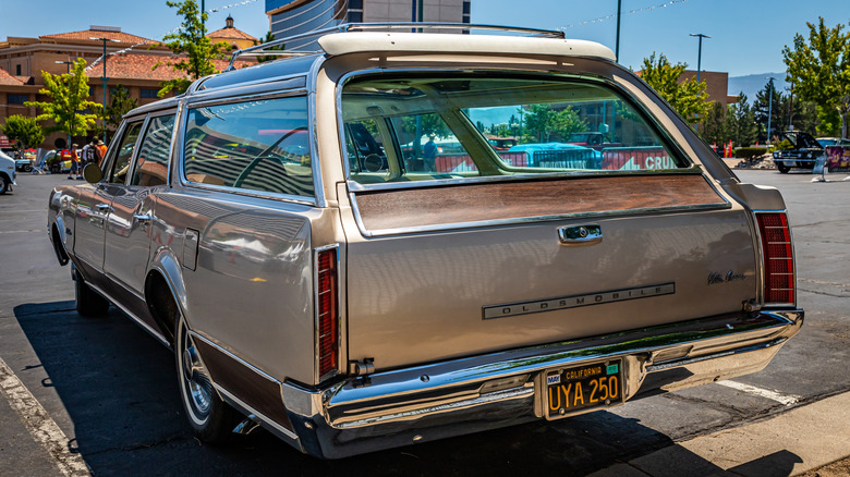 Rear shot of a gold '67 Oldsmobile Vista Cruiser in a parking lot