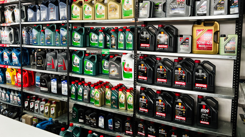 Different makes and brands of motor oil on a store shelf