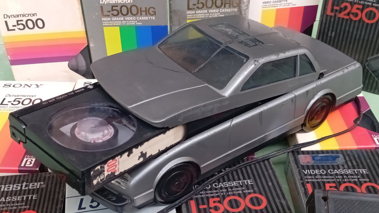 A vintage VHS tape rewinder in the shape of a car.