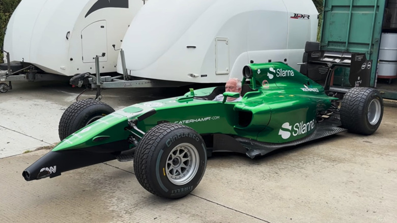 Kevin Thomas sits in his green frankensteined 2014 Caterham F1 car he built.
