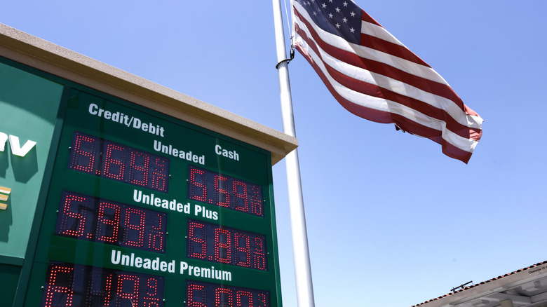 An American flag flies above gas prices displayed at a gas station on May 11, 2026 in Arcadia, California.