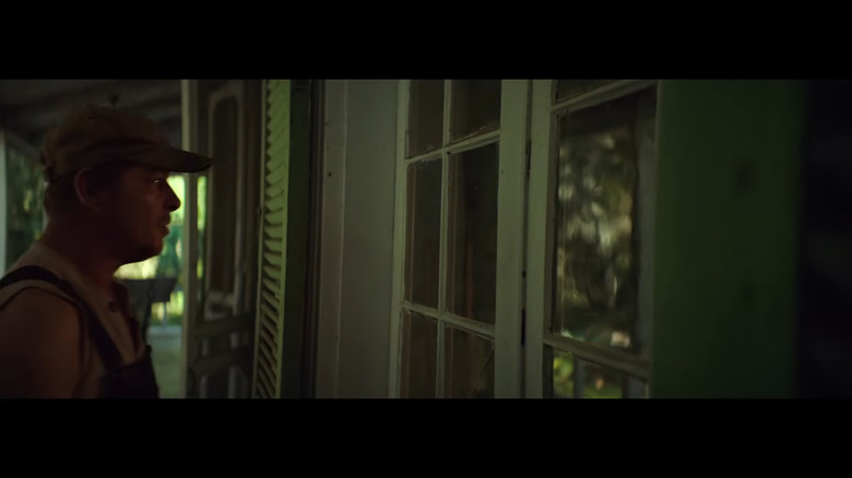 A man walks up to a house