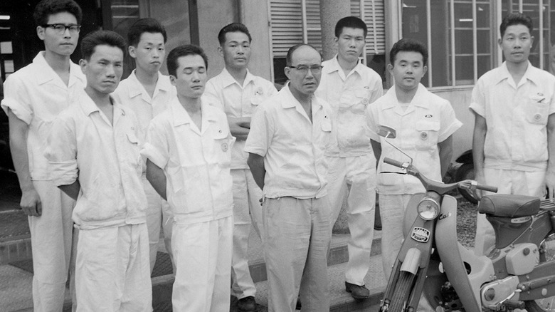Soichiro Honda with the Super Cub's development team.