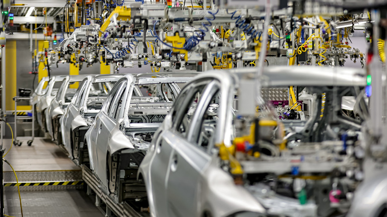 look at the body shop finish during German Chancellor Olaf Scholz visits the BMW Group car factory on December 05, 2023 in Munich, Germany.