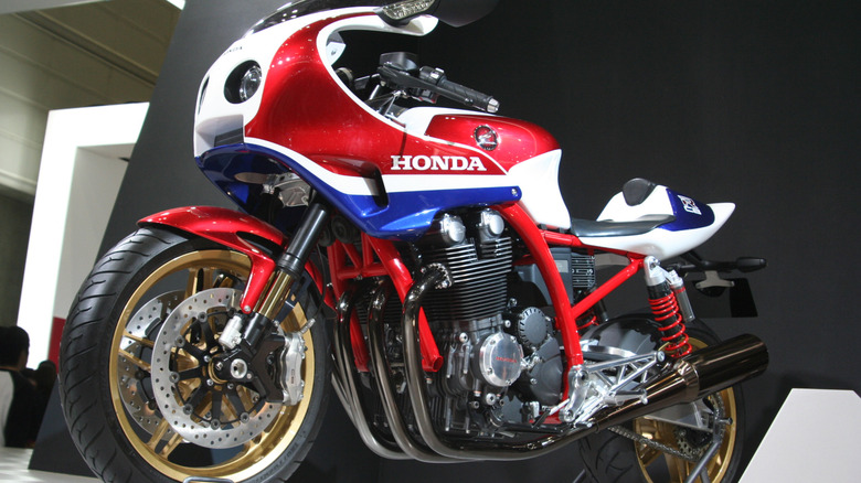 A 1981 red, white, and blue Honda CB1100R on display at a moto exhibition.