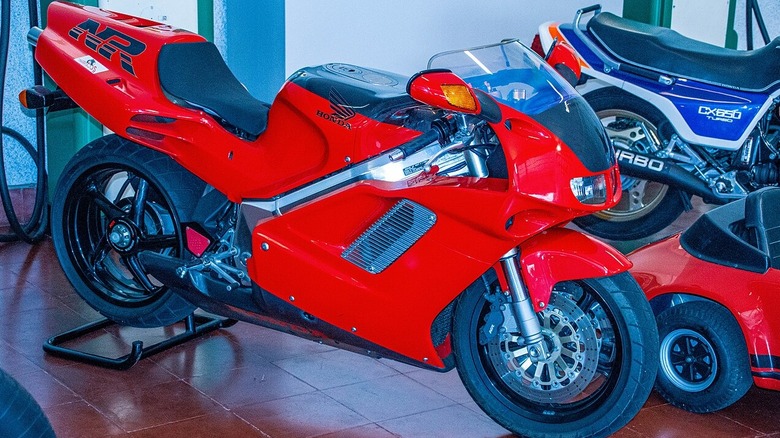 A red vintage 1992 Honda NR750 at a motorbike expo.