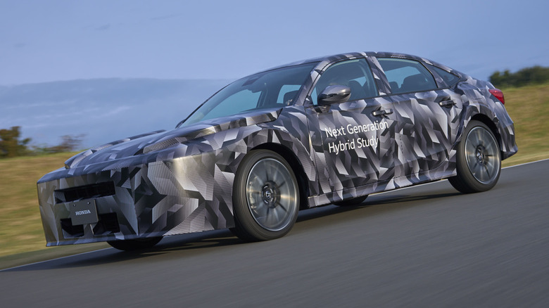 Front 3/4 view of a camouflaged Honda Next Generation Hybrid Study on track