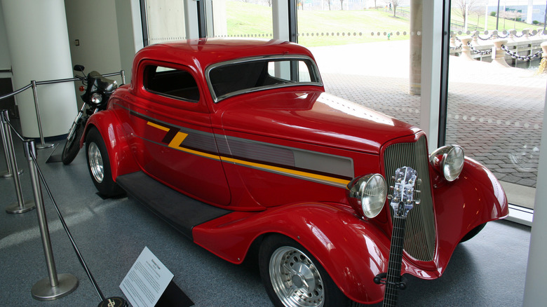 Red 1933 Ford coupe hot rod known as ZZ Top's Eliminator seen from right front three-quarter view on display indoors at the Rock and Roll Hall of Fame, Cleveland, Ohio