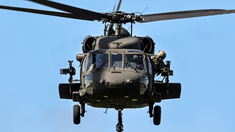 A U.S. Army Black Hawk helicopter against a blue sky