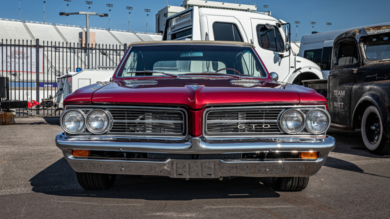A front-end view of a red 1964 Pontiac GTO.