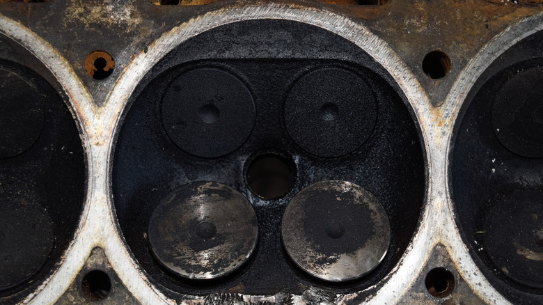 Carbon buildup in an internal combustion engine's cylinder head.
