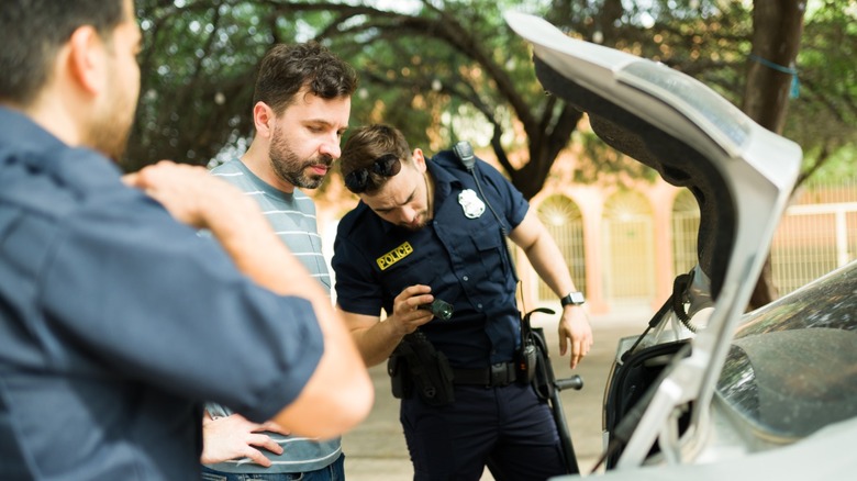 Police search a man's car