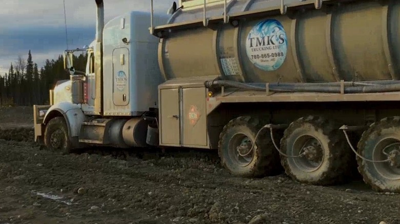 Semi truck driving through mud