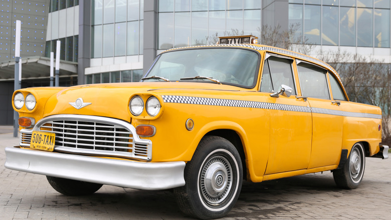 A Checker Marathon cab parked on a street.