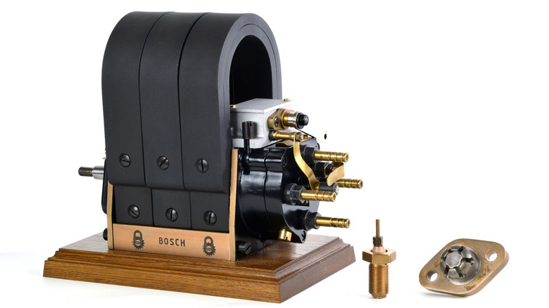 A Bosch high-voltage magneto ignition system with its first spark plug from 1902.