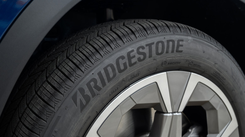 A close-up of a Bridgestone tire on a blue crossover