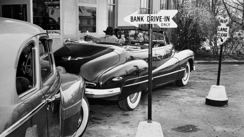 A man driving a Buick Super parked alongside the teller's window at the Bayside National Bank's drive-thru branch in Bayside, Long Island, 29th March 1949. (Photo by Al Gretz/Keystone Pictures/FPG/Archive Photos/Getty Images)