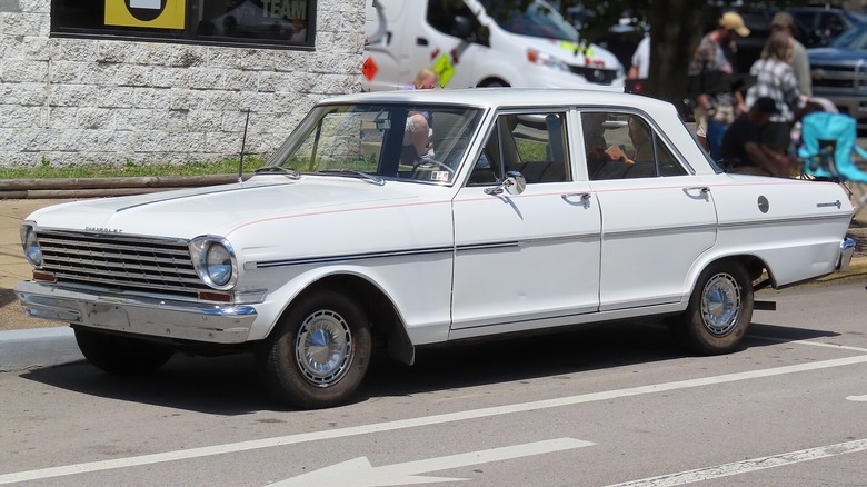 Front 3/4 of white 1963 Chevrolet Chevy II 300 sedan parked on street