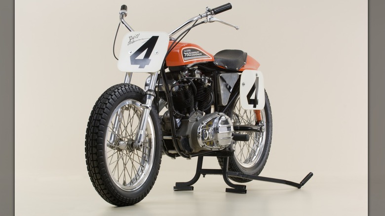 A side view of a Harley-Davidson XR-750 flat track motorcycle on a center stand