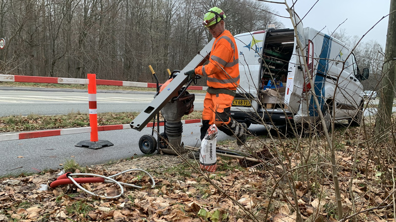 A Danish electrical worker installing the red streetlights.