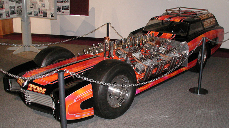 TV Tommy Ivo's orange Buick Nailhead four engined dragster on display in a museum.