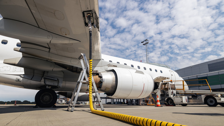Refueling of airplane at airport. Ground service before flight.
