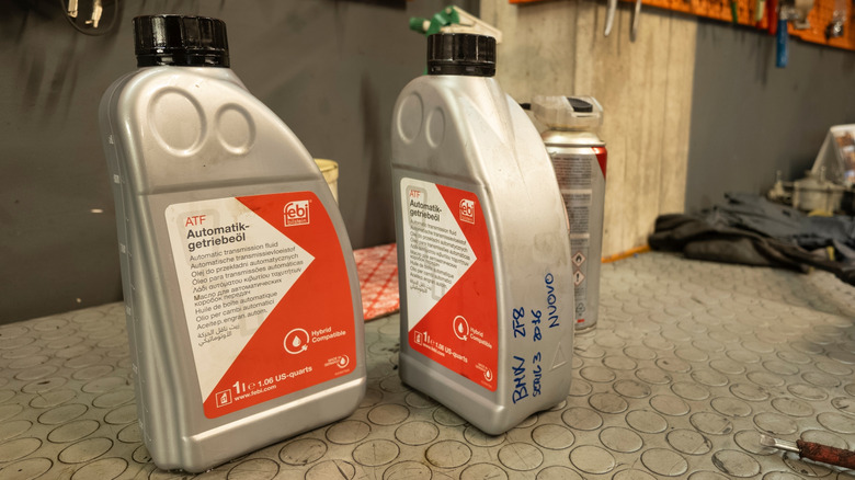 Two bottles of ATF on a garage table