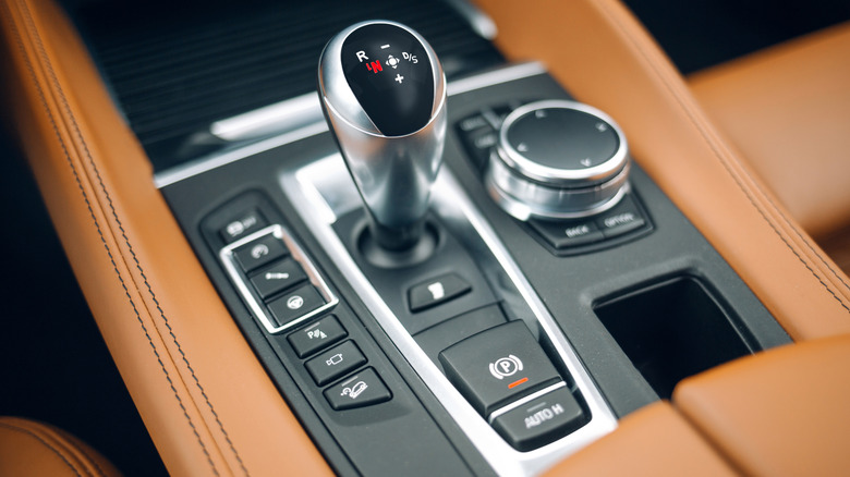 a adjacent up image of nan cogwheel shifter successful a car pinch a semi-automatic transmission