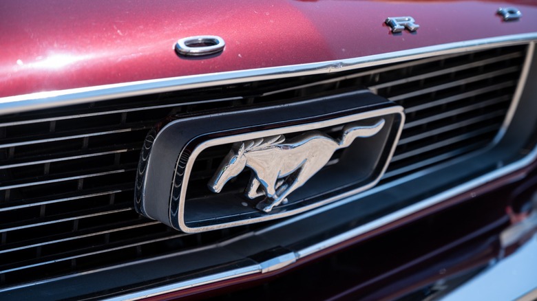 Closeup of beforehand grille and badge of a classical Ford Mustang