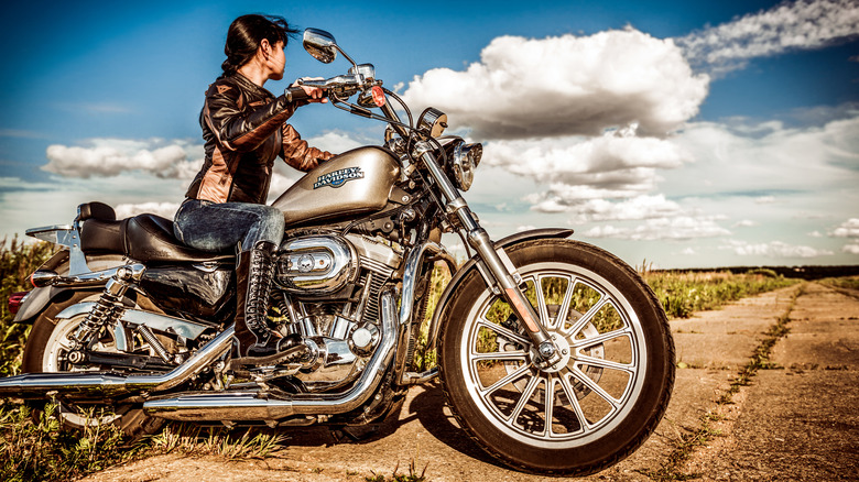 A woman riding a Harley-Davidson motorcycle