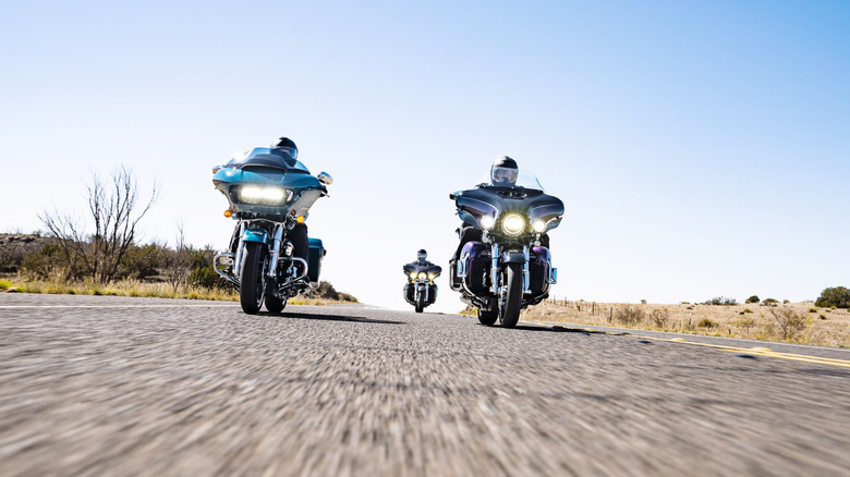 A trio of riders in Harley-Davidsons on the highway