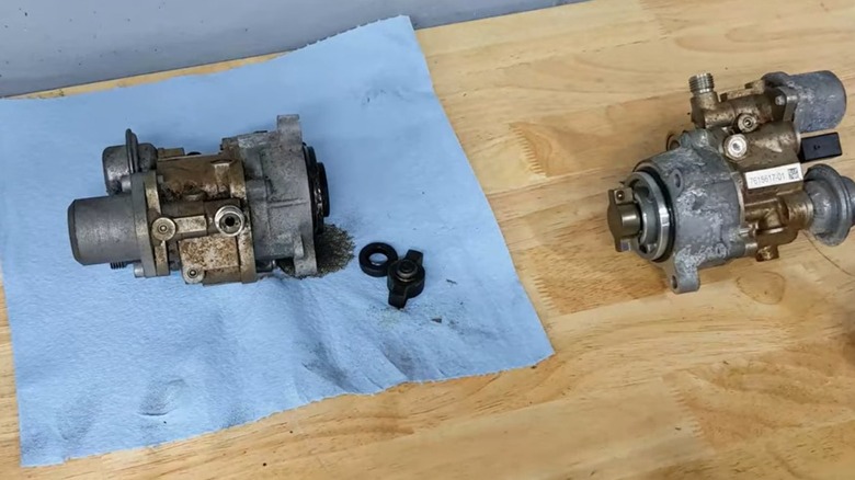 Failed high pressure fuel pump from a BMW N54 engine and its new replacement