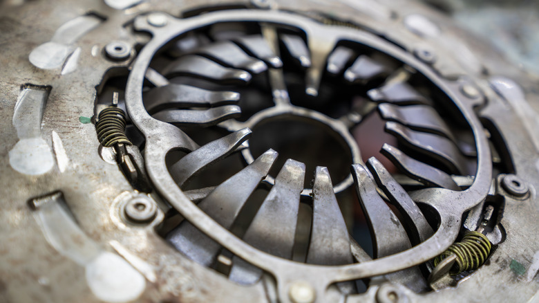 A close-up of a used car clutch pressure plate assembly.